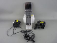 Two vintage Nokia mobile phones with chargers