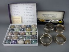 Four silver napkin rings and a pair of boxed golfing spoons along with a boxed collection of semi-