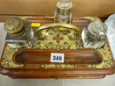 Victorian oak desk stand with Gothic type brass mounts and three various ink bottles
