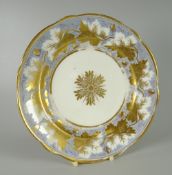 A NANTGARW PORCELAIN PLATE of lobed form decorated with a continuous vine of gilded leaves on