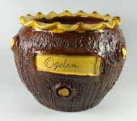 A BUCKLEY POTTERY JARDINIERE of textured bark form, pie-crust rim and with slip decoration and