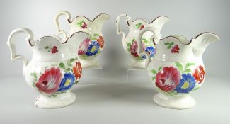 FOUR SWANSEA POTTERY POUCH JUGS of bellied form with scroll handles, chocolate rims and colourful