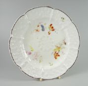 A NANTGARW PORCELAIN CRUCIFORM PLATE WITH DAISY MOULDING decorated with three sprays of flowers