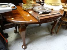 An antique mahogany extending dining table
