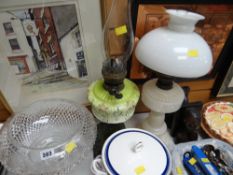 An impressive cut glass pedestal fruit bowl, two oil lamps & a pair of ethnic art bookends