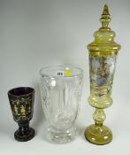 A heavy quality glass footed-vase, a Bavarian coloured-glass transfer decorated vase & another