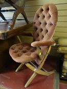 A buttoned velvet covered adjustable elbow chair