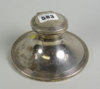 A circular based silver mounted inkwell with hinged lid inscribed & dated 1910