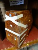 A small aircraft luxury walnut flight cabinet with three drawers