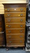 A good reproduction-antique mahogany narrow chest of seven graduated drawers with decorative