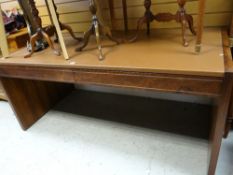 A mid-century two drawer rosewood leather topped desk