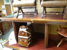 An antique-style office desk with tooled red leather top