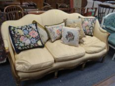 A good serpentine three-seater settee with carved floral supports on reeded legs with studded
