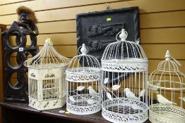 A native-arts grotesque wine rack & four metallic bird cages
