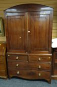An antique mahogany press-cupboard, the base with two long & two short drawers and having a dome-top