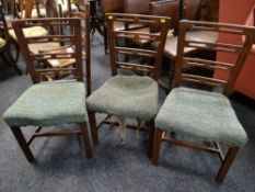 A set of three railback farmhouse chairs with added cushions