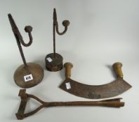 A parcel of four farmhouse items including two antique rush-light holders on wooden stands, a bladed