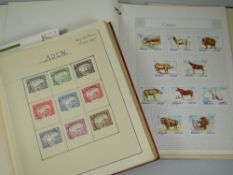 A vintage red Strand stamp album, sparsely completed together with a blue Ace Advance album,