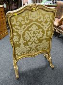 A Rococo style gilded & ebonized carved fire screen with double-side silk fabric panel