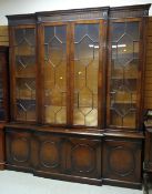 A good reproduction-antique bookcase cupboard with astragal glazing & a base composed of four