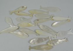 A collection of approximately twenty mother of pearl novelty gaming counters in the form of fish