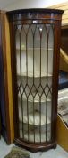 A demi-lune floor standing single-door glazed corner cabinet (damage - please be careful)
