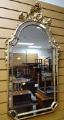 A reproduction Rococo-style mirror with shell finial