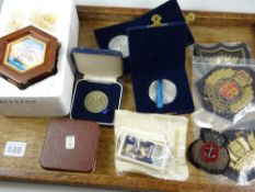 A tray of commemorative items including a silver pendant for Prince Charles & Lady Diana, four