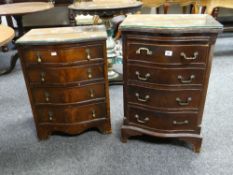 A pair of reproduction serpentine chests of four drawers (distressed)