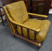 A good reproduction antique library-type chair with leather cushions & studded leather arms & back