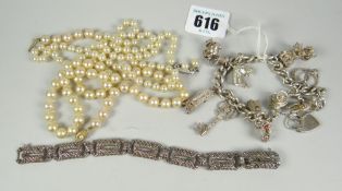 A silver charm bracelet, 58.5grms together with simulated pearls & a marcasite bracelet