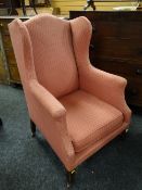 A good vintage wing-back armchair in pink geometric upholstery