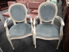Two modern French-style salon chairs with pale blue upholstery