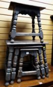 An antique nest of three oak carved tables or stools & another