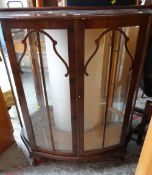 A vintage bow front two-door polished china cabinet