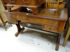 A reproduction writing desk with a bank of four drawers & tooled brown leather top