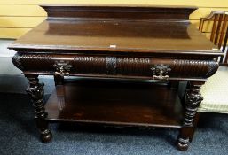 An antique mahogany buffet sideboard with carved features & copper handles, 121cms wide