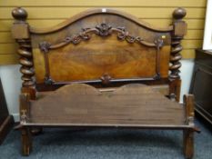 An antique mahogany elaborately carved bed-end with barley-twist supports