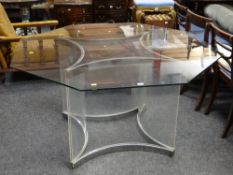 An Alessandro Albrizzi octagonal glass top table with concave chrome & Perspex base, 137cms diam