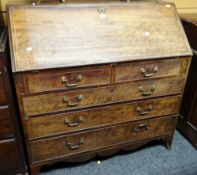 An antique mahogany bureau composed of three long & two short drawers, the sloped front revealing an