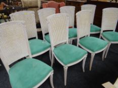 A set of eight French-style painted twin-cane bergere chairs with stuff-over seats