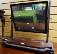 An antique mahogany toilet mirror on bun feet with reeded supports & beaded border decoration