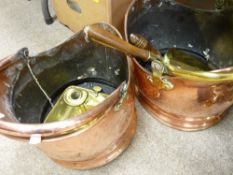 Two copper helmet coal scuttles, brass candleholder and two brass coal shovels