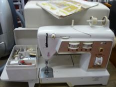 Cased Singer electric sewing machine and accessories E/T