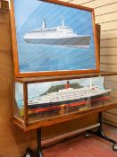 Glass encased model ship 'Cunard Queen Elizabeth II' and a framed print of the QEII