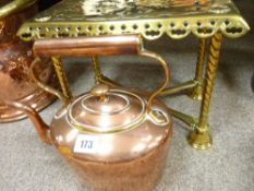 Antique copper kettle and brass trivet stand
