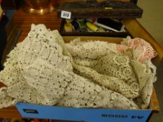 Dragon carved wooden box with haberdashery contents and a parcel of old table linen