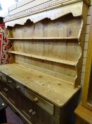 Pine dresser of three base drawers over four cupboard doors