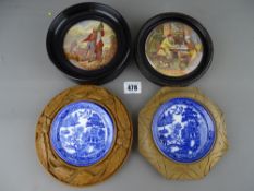 Pair of Willow pattern butter dishes in carved mounts and two wooden framed Pratt ware pot lids