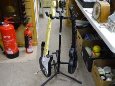 Guitar stand containing a 'Guitar Hero' games machine and another